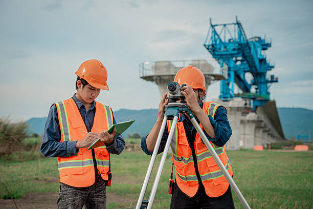 istock Engineers are conducting land surveying construction site using theodolite instrument mounted tripod measure land levels and distances project planning in the civil engineering and industrial development sector. 2233929609