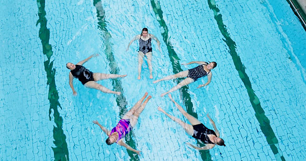 istock High Angle Shot of Five Senior Women Practicing their Synchronized Swimming Routine 2233937464