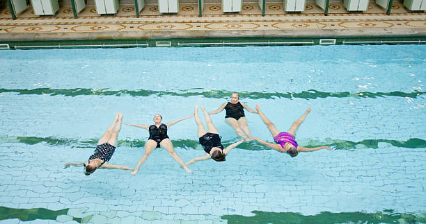 istock High Angle Shot of Five Senior Women Practicing their Synchronized Swimming Routine 2233937526