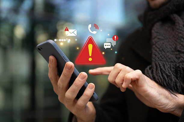 istock Man using smartphone with red alert and warning icons. 2233939132
