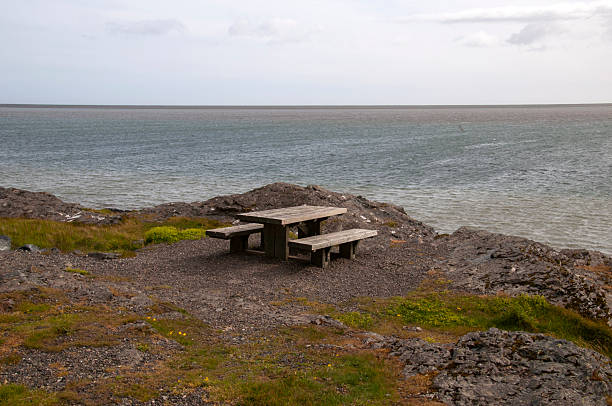 istock Picnic table and seats with ocean in background 2233947732