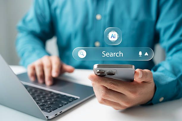 istock AI search engine concept with digital interface on smartphone and laptop. Businessman using smart technology for online search, voice query, and intelligent information discovery. 2233948756