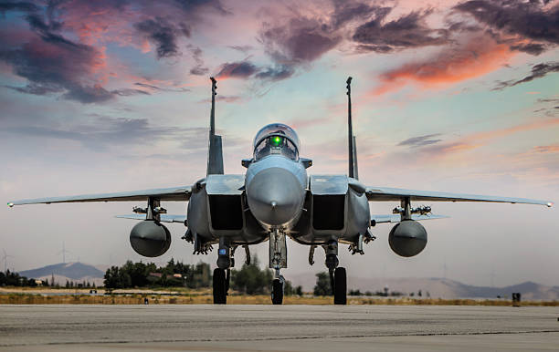 istock F-15 Eagle FighterJet on runway at sunset 2233949684