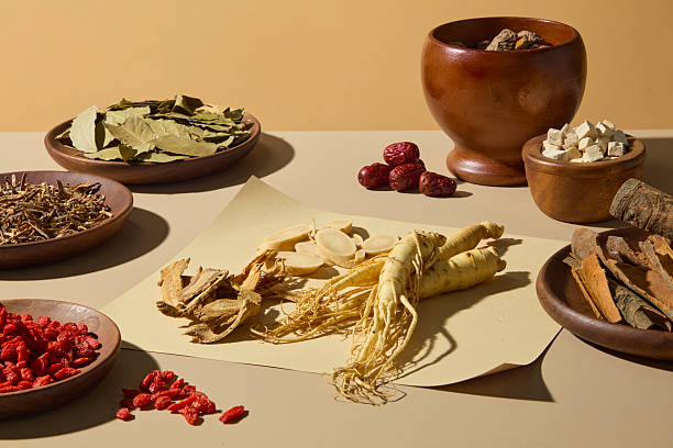 istock Flat-lay composition showing ginseng roots and assorted dried herbs in wooden bowls, styled with a rustic aesthetic for traditional medicine presentation. 2233952380