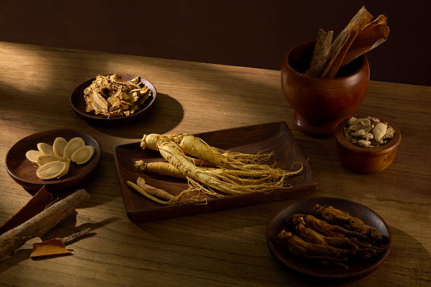 istock Overhead shot of a rustic setup with ginseng roots, cinnamon sticks, and other oriental medicine herbs. Earthy wooden background enhances mood. Asian herbal apothecary photography 2233952558