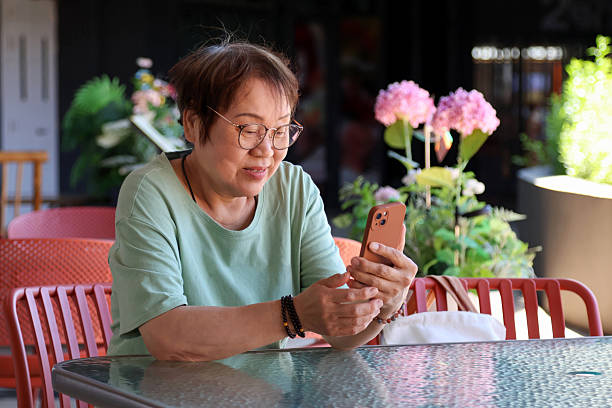 istock An elderly Asian woman using a mobile phone 2233953149