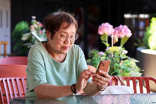 istock An elderly Asian woman using a mobile phone 2233953150