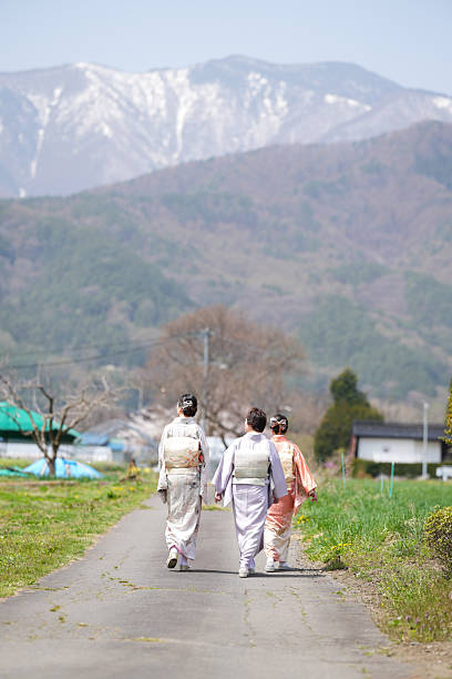 istock Three women are walking down a road in the countryside 2233953383