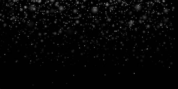 istock White snowflakes. Snow flakes. Falling snow on a dark black background. Realistic snowflakes, and isolated snowfall. Overlay stock photo for Christmas designs and digital artwork. Night snowfall.  Isolated effect for overlays. Natural Winter 2233955327
