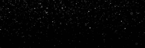 istock White snowflakes. Snow flakes. Falling snow on a dark black background. Realistic snowflakes, and isolated snowfall. Overlay stock photo for Christmas designs and digital artwork. Night snowfall.  Isolated effect for overlays. Natural Winter 2233955341
