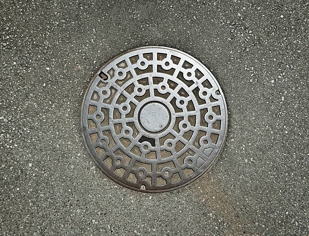 istock manhole, metal, sewage, road, sidewalk 2233955382