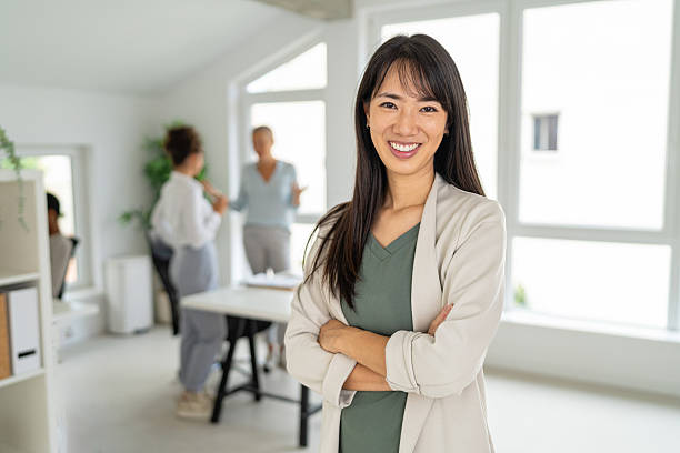 istock Confident businesswoman standing in a bright modern office environment 2233956856