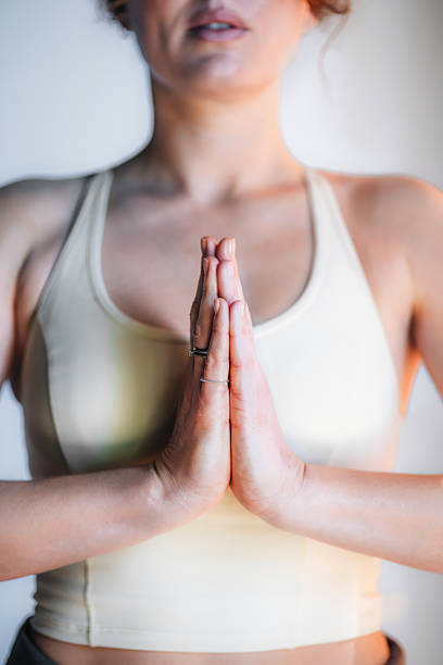 istock Woman Practicing Yoga with Hands in Prayer Pose for Relaxation and Mindfulness 2233956926