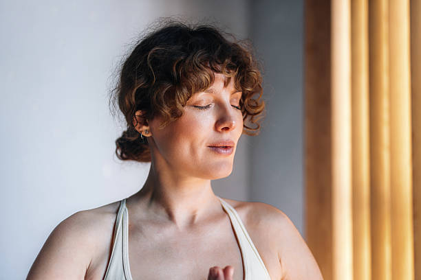 istock Serene Woman Practicing Meditation and Mindfulness in a Sunlit Room 2233956957
