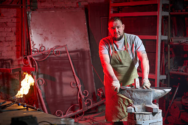 Portrait Of Young Blacksmith Standing In Front Of His Workshop