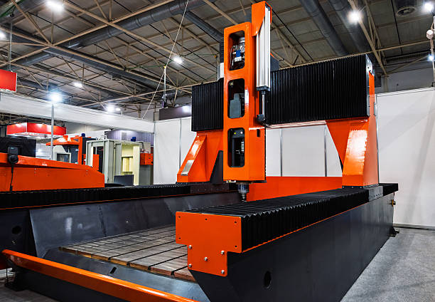 istock Powerful orange and black CNC machine in an industrial setting, showcasing automated manufacturing technology for precision metalworking or material processing in a factory environment. 2233966245