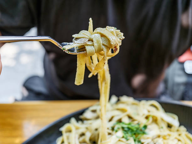 istock delicious fettuccine alfredo on fork 2233968919