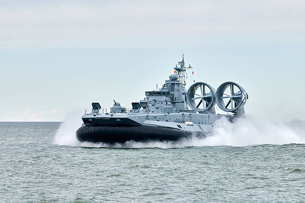 istock Hovercraft warship armed with armament sails into sea toward military target to attack and destroy 2233970876