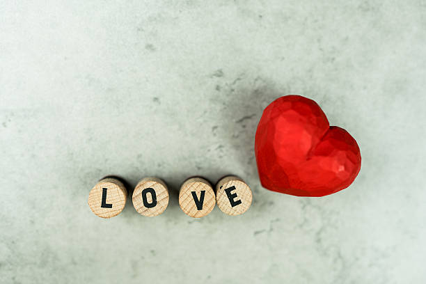 istock Text of LOVE with wood red hearts 2233971171