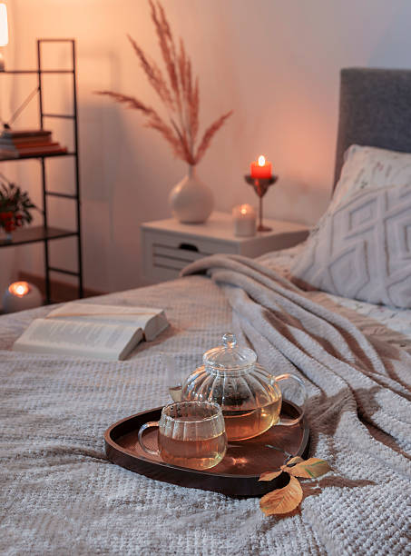 istock cup of tea on cozy bed with autumn decorations 2233972864