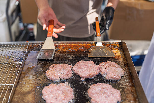 istock Sizzling hamburger patties on the iron plate 2233972957