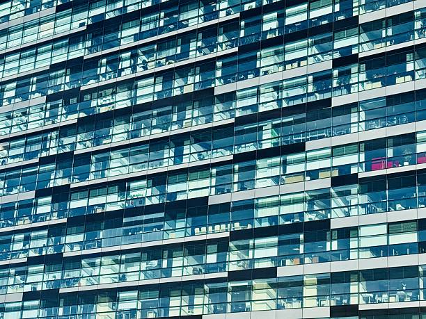 Modern Glass Facade Architecture in an Urban Environment That is Both Dynamic and Stylish. This stylish glass building exterior beautifully showcases cuttingedge modern architectural design.