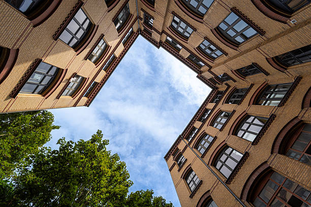 Germany, Berlin, Schöneberg, September 01, 2025 - Courtyard of a residential building with tree