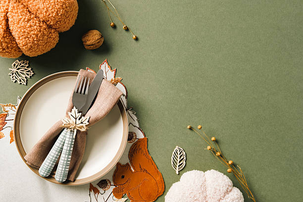 istock Cozy autumn table setting with plate, napkin, wooden leaves, pumpkins, nuts, and rustic decor, ideal for Thanksgiving, harvest celebrations 2233982632