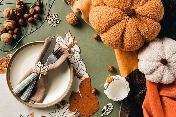 istock Elegant autumn table setting with fabric pumpkins, nuts, candle, and embroidered linens, perfect for Thanksgiving, harvest celebrations, and cozy seasonal home decor inspiration 2233982665