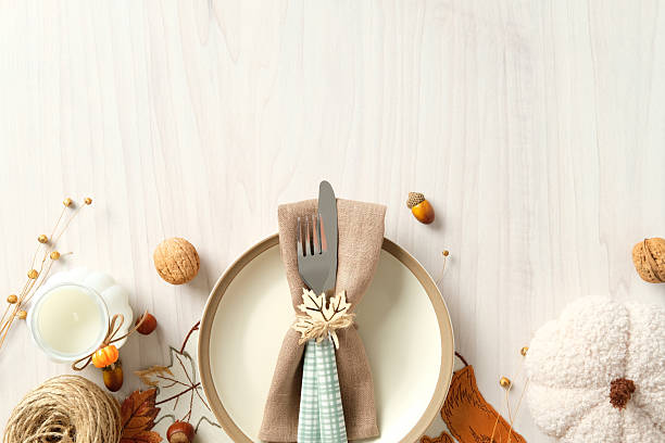 istock Autumn table setting with plate, napkins, cutlery with maple leaf ring, pumpkins, nuts, candle, and rustic decor 2233982861