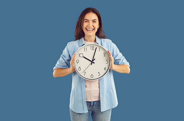 istock Happy excited young woman holding big wall clock 2233988083