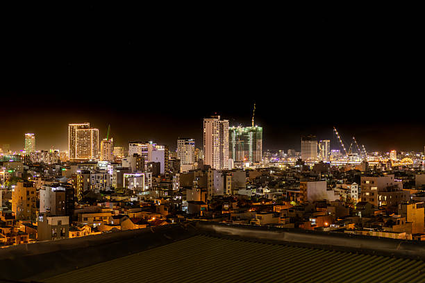 Night view of Da Nang, Vietnam, with illuminated city skyline, modern buildings, and vibrant lights reflecting urban life in central Vietnam