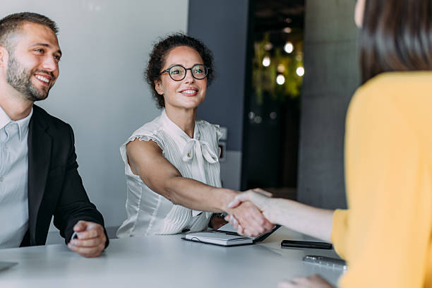 istock Businesspeople shaking hands across the table. 2233988891