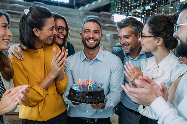 istock Team celebrating a birthday at the office. 2233988956