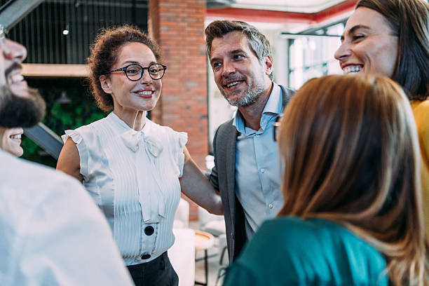 istock Excited coworkers embracing each other during a celebration in the office. 2233988968