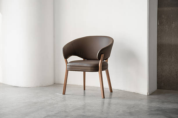 istock Brown armchair against beige wall. 2233989819
