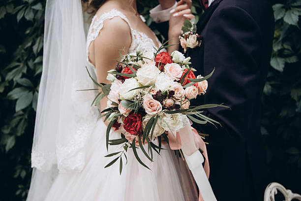 istock Wedding couple with a beautiful bouquet in their hands 2233990258