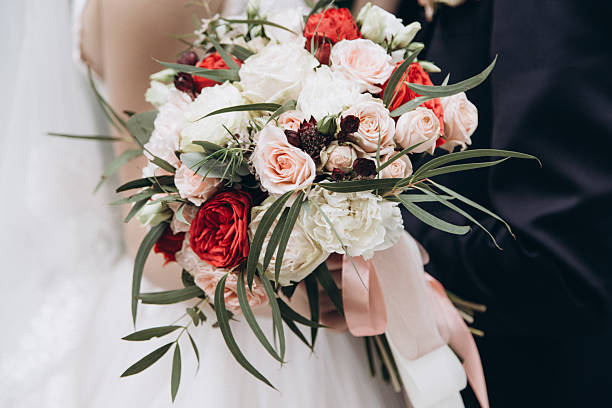istock Wedding couple with a beautiful bouquet in their hands 2233990289