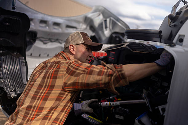istock Focused Male Truck Driver Fixing Engine 2233993776