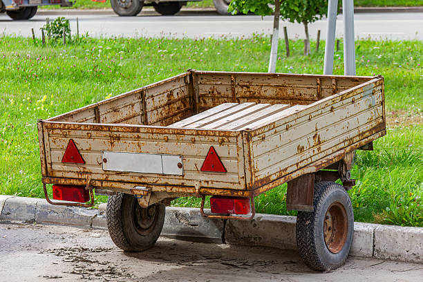 istock Rusty utility trailer parked near a grassy area 2233994259