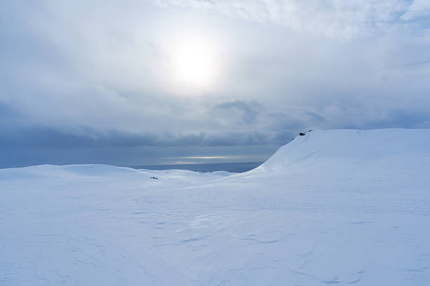 Scenic view of white snowfield and glacier mountain ridge during winter in Iceland