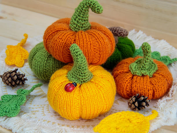 istock Autumn decorations. Knitted pumpkins, cones, leaves, ladybug. We make Halloween decorations with our own hands. 2233994388