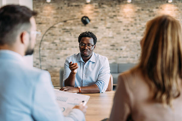istock Group of business persons talking in the office. 2233994812