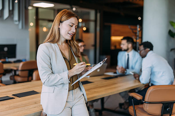 istock Confident businesswoman and her team. 2233994815