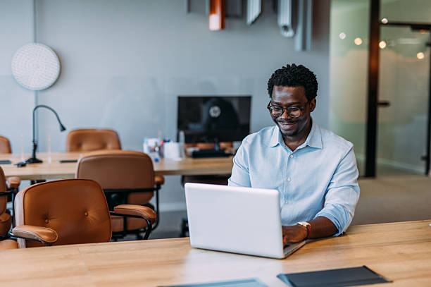 istock Successful businessman in modern office working on laptop. 2233994840