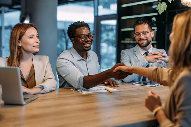 istock Businesspeople shaking hands across the table. 2233994849