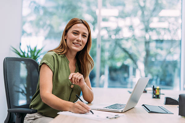 istock Successful businesswoman in modern office working on laptop. 2233994878