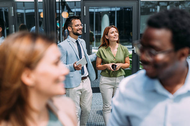 istock Business people talking outside of office building. 2233994880