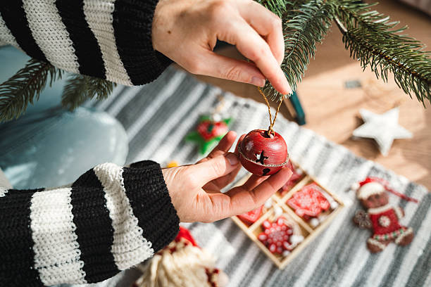 istock Hanging a Bell Ornament on a Christmas Tree 2233995650