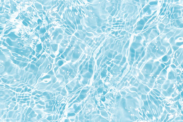 istock Blue water with ripples on the surface. Defocus blurred transparent blue colored clear calm water surface texture with splashes and bubbles. Water waves with shining pattern texture background. 2233995850